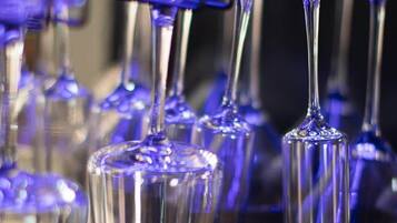 A row of empty wine glasses on a shelf.