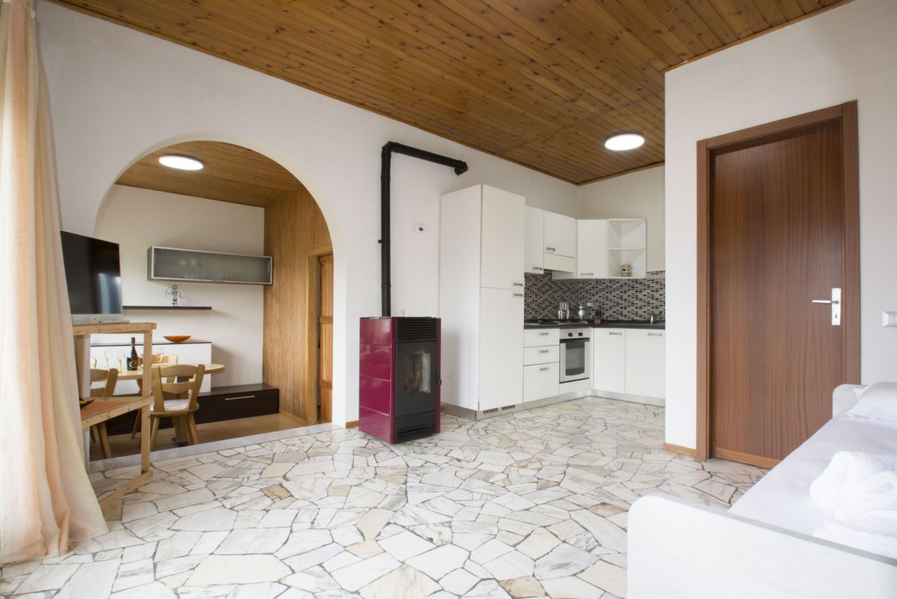 Una cocina moderna con armarios blancos, una estufa negra y un salpicadero de azulejos.