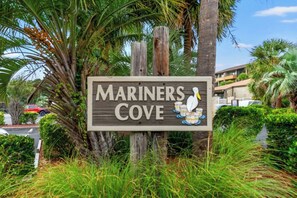 A wooden sign with the text 'MARINERS COVE' and a duck illustration. - Mariner's Cove 230C-2BR Condo in Shore Drive (Myrtle Beach)