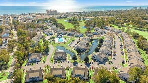 A residential area with houses, a golf course, and a body of water. - Fairway Oaks 44C-Cherry Grove 3BR- Community Pool (North Myrtle Beach)