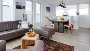 A modern living room with a grey sofa, a wooden coffee table, and a patterned rug. - Houseboat in Kappeln With Swimming Pool (Kappeln)