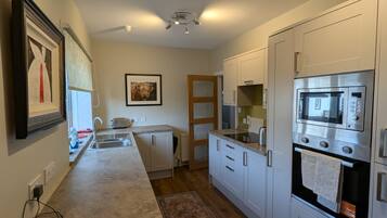 Coffee/tea maker, fridge, microwave, oven