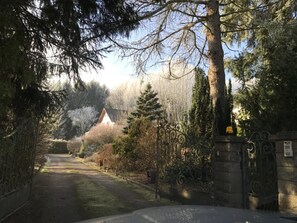 A gated driveway leading to a building surrounded by trees. - Holiday Residence in North Vosges (Bitche)