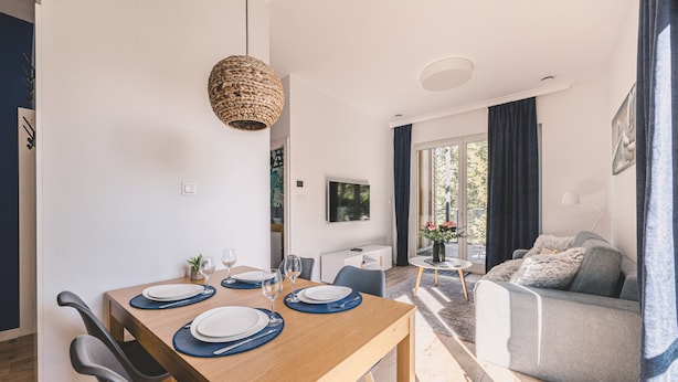 Un espacio moderno para vivir con comedor, sofá y televisor.