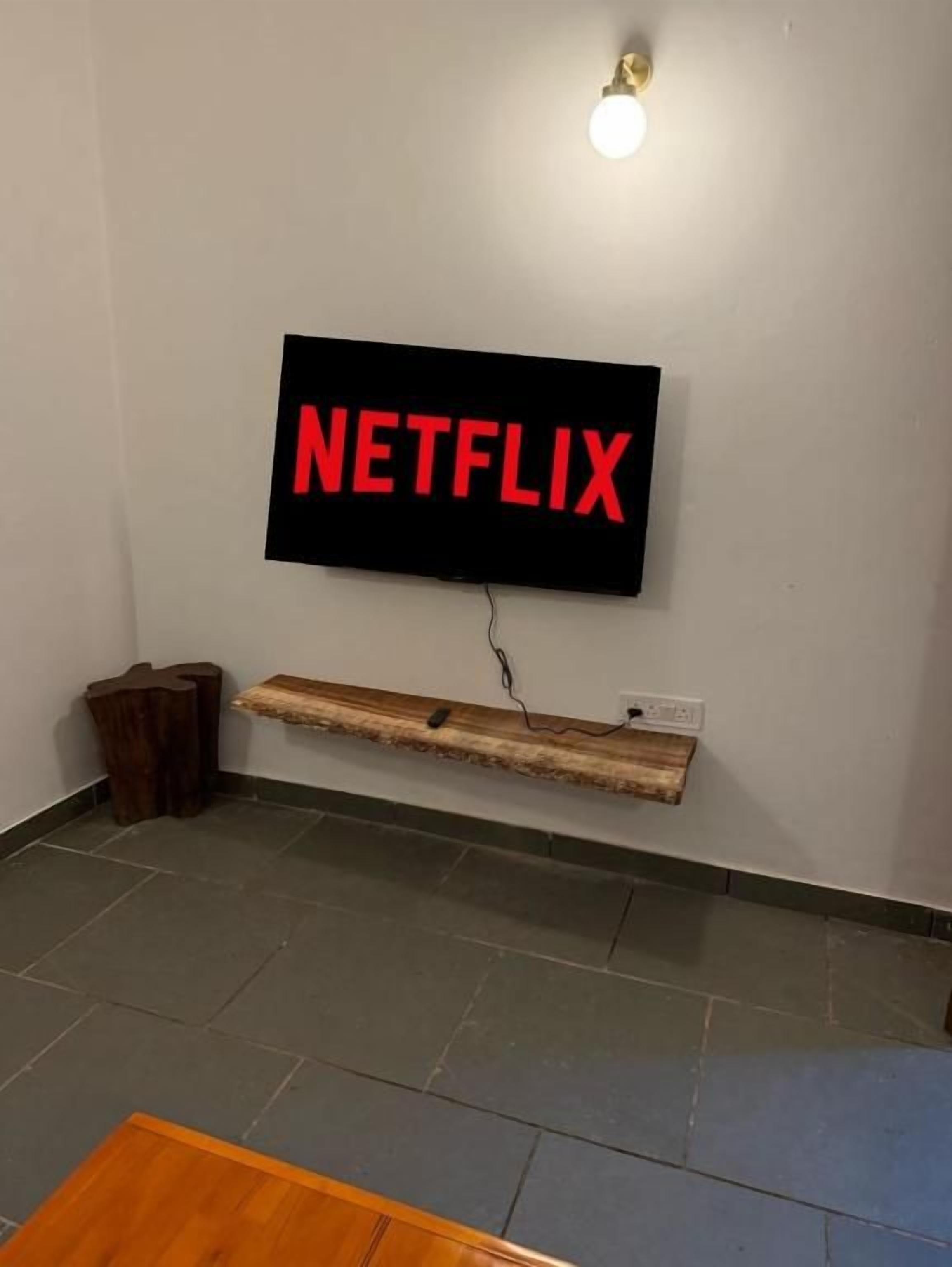 A wall-mounted television with the word 'NETFLIX' in red letters.