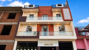 A multi-story building with a sign reading 'Mangal Bhawan Home Stay'. - Classic Ayodhya Junction Road (Faizabad)