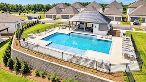 A residential area with a swimming pool, lounge chairs, and a covered patio. - The Archie, 2mi to Campus & Sq Velvet Ditch Villas (Oxford)