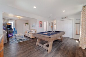 A room with a pool table, a sofa, a coffee table, a pool table with balls, a pool table with cues, a pool table with a ball, a pool table with a ball, a pool table with a ball, a pool table with a ball, a pool table with a ball, a pool table with a ball, a pool table with a ball, a pool table with a ball, a pool table with a ball, a pool table with a ball, a pool table with a ball, a pool table with a ball, a pool table with a ball, a pool table with a ball, a pool table with a ball, a pool table with a ball, a pool table with a ball, a pool table with a ball, a pool table with a ball, a pool table with a ball, a pool table with a ball, a pool table with a ball, a pool table with a ball, a pool table with a ball, a pool table - JLJR #107 Memory Maker, Semi-Oceanfront, 1 min walk to beach, Pool Hot Tub Pets (Nags Head)