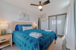 A bedroom with a bed, a ceiling fan, a door, and a view of the outside. - JLJR #107 Memory Maker, Semi-Oceanfront, 1 min walk to beach, Pool Hot Tub Pets (Nags Head)