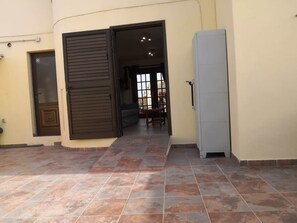 An open door leading to a room with a tiled floor and a refrigerator. - VvCasa Maruca (Internet Access - 1 GB) (Castillo Caleta de Fuste)