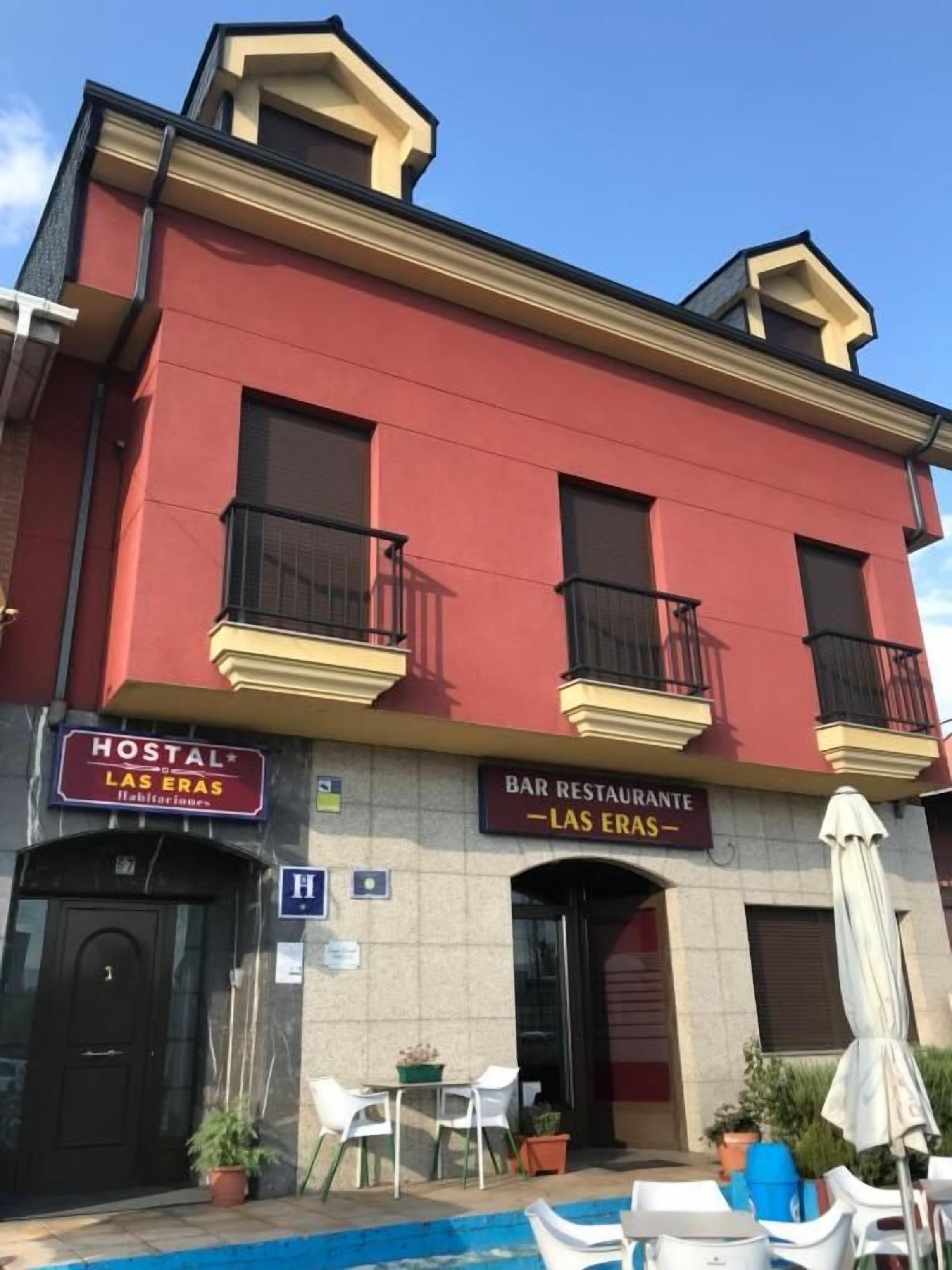 A building with a sign for a hostel and a bar restaurant.
