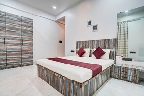 A modern bedroom with a large bed, a wardrobe, a mirror, and a bedside table. - DanCenter Villa Viva 5BHK with Pvt Pool (Lonavala)