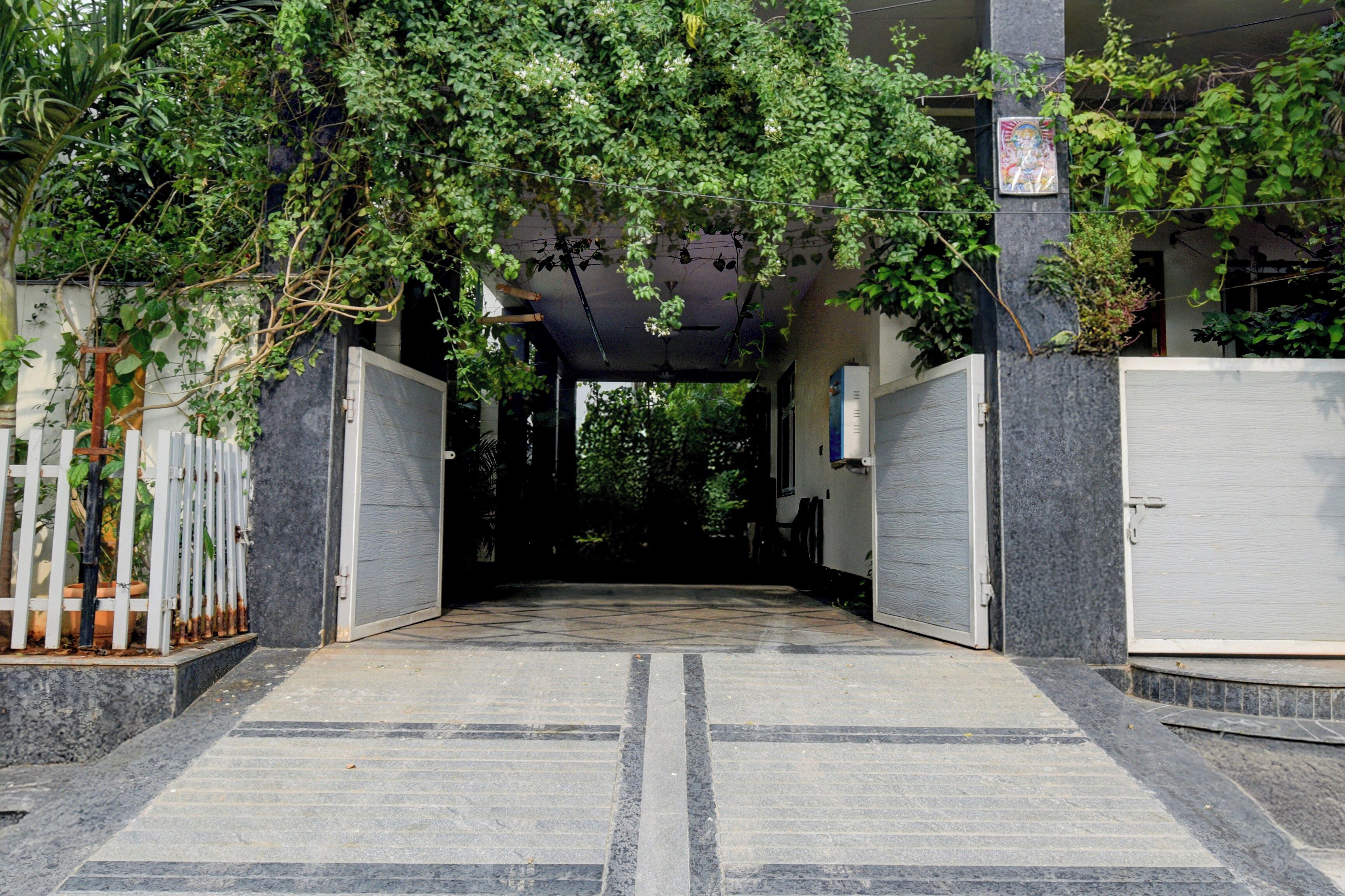 A covered entrance with a tiled floor leading to a building.