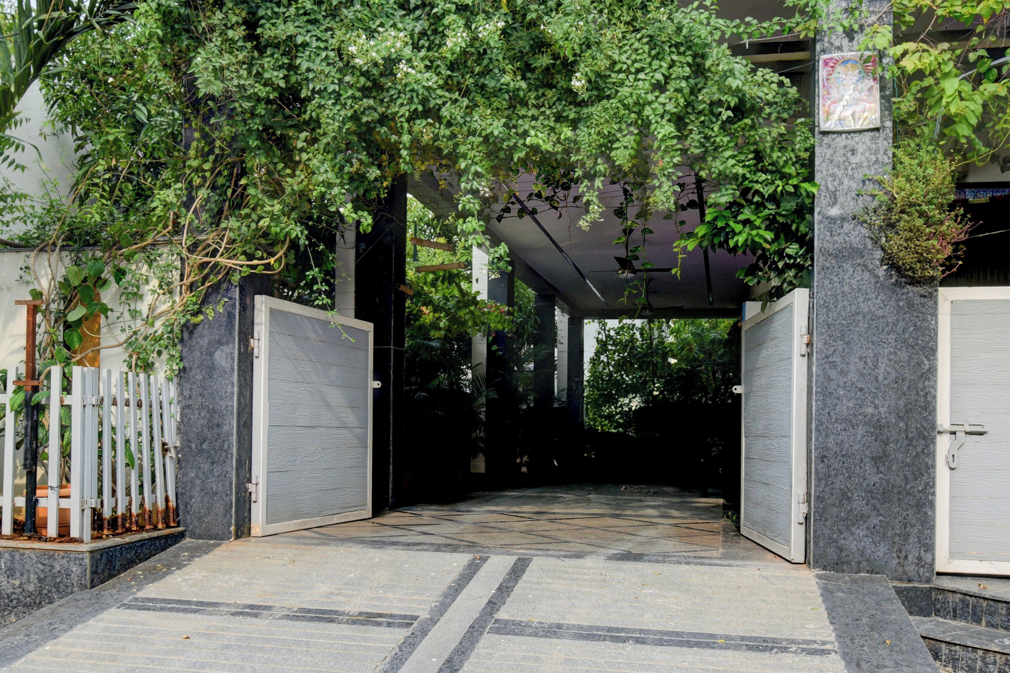 A covered entrance with a tiled floor leading to a building.