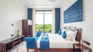 A modern bedroom with a bed, bedside tables, a desk, and a chair.