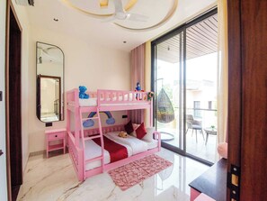 Una cama litera infantil con juguetes, una mesita de noche pequeña, un espejo y vistas al exterior.