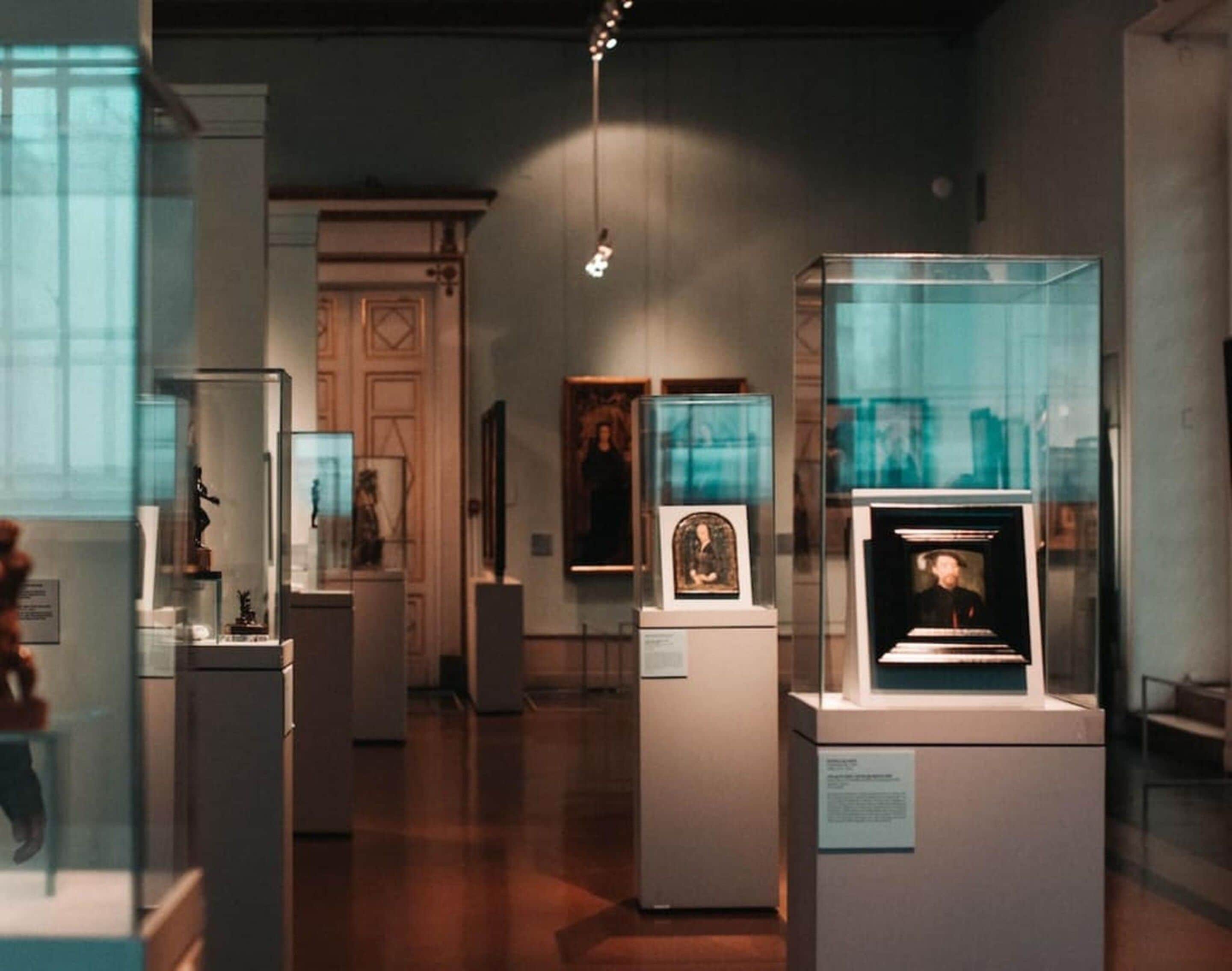 An indoor exhibition space with glass display cases containing various items.