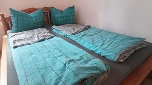 A bed with a headboard, two pillows, and a blanket. - Cozy vacation rental near the harbor (Wismar)