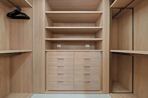 A wooden wardrobe with multiple shelves and drawers. - Newport Beach | Luxury Condo | Steps to Sand (Newport Beach)