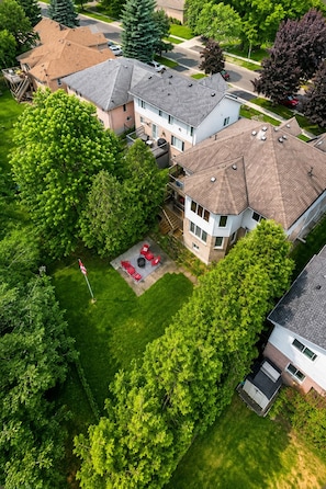 A residential area with multiple houses, a well-maintained lawn, and a flagpole.