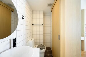 A bathroom with a white bathtub, a toilet, and a towel rack. - Kamala - Peaceful Jungle View (Tambon Kamala)