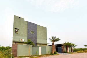 Un edificio moderno con tejado plano, un ventanal grande y una puerta.