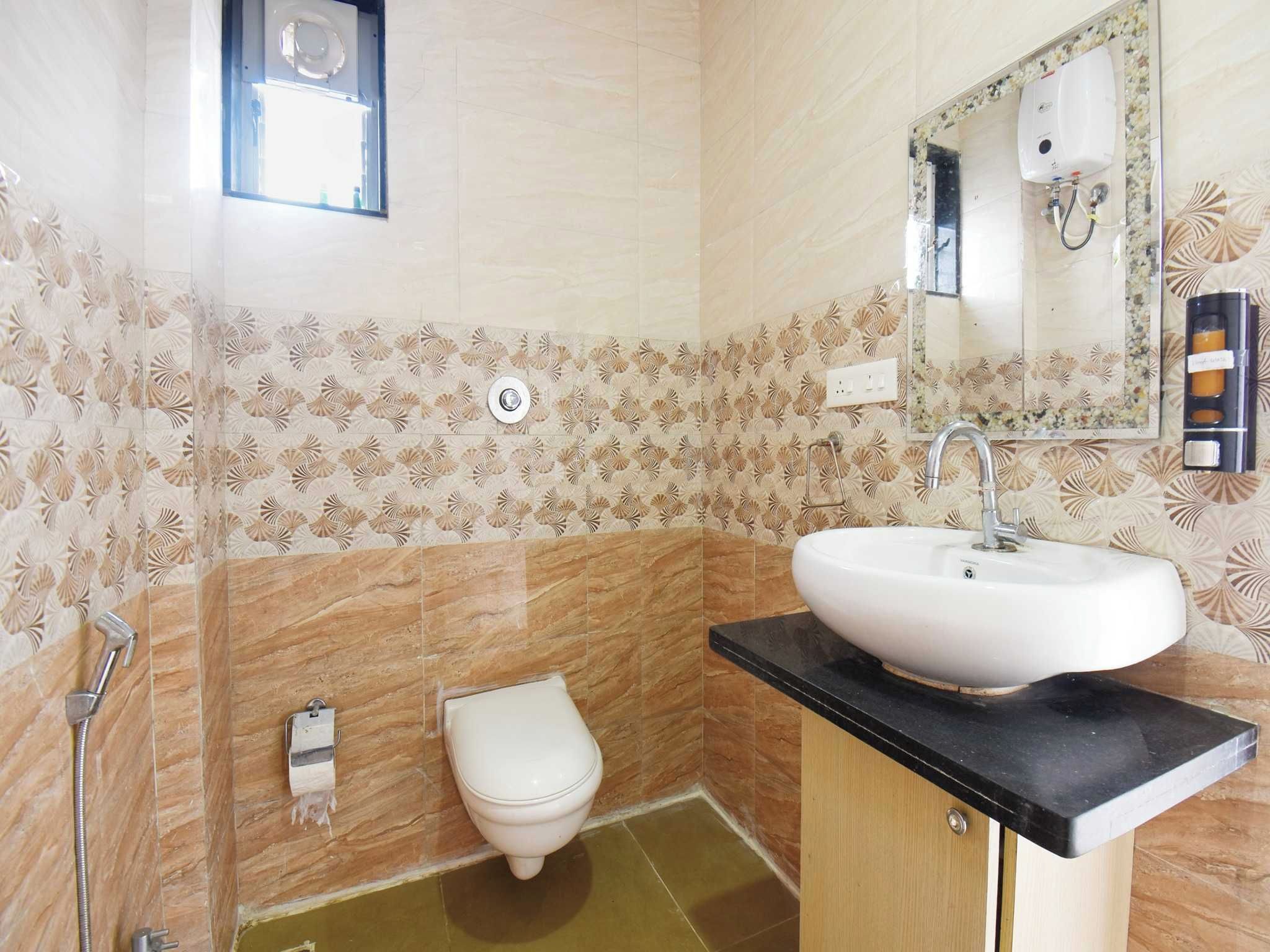 A bathroom with a toilet, sink, and shower.