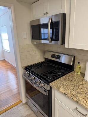 A kitchen with a stainless steel stove, oven, and microwave. - Cozy 2-bedroom house in peaceful Corpus Christi close to hospital beach downtown (Corpus Christi)