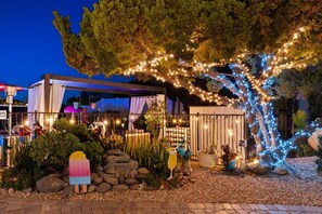 A garden area with a pergola, potted plants, and decorative lighting. - Resort style, Hillside views, Lux pool, near golf courses (Spring Valley)