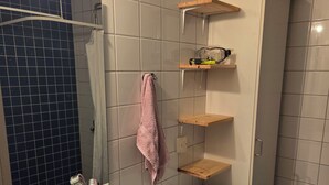 A bathroom with a sink, mirror, towel rack, and a washing machine. - Luxury Apartment - The subway is right outside the apartment (Stockholms län)