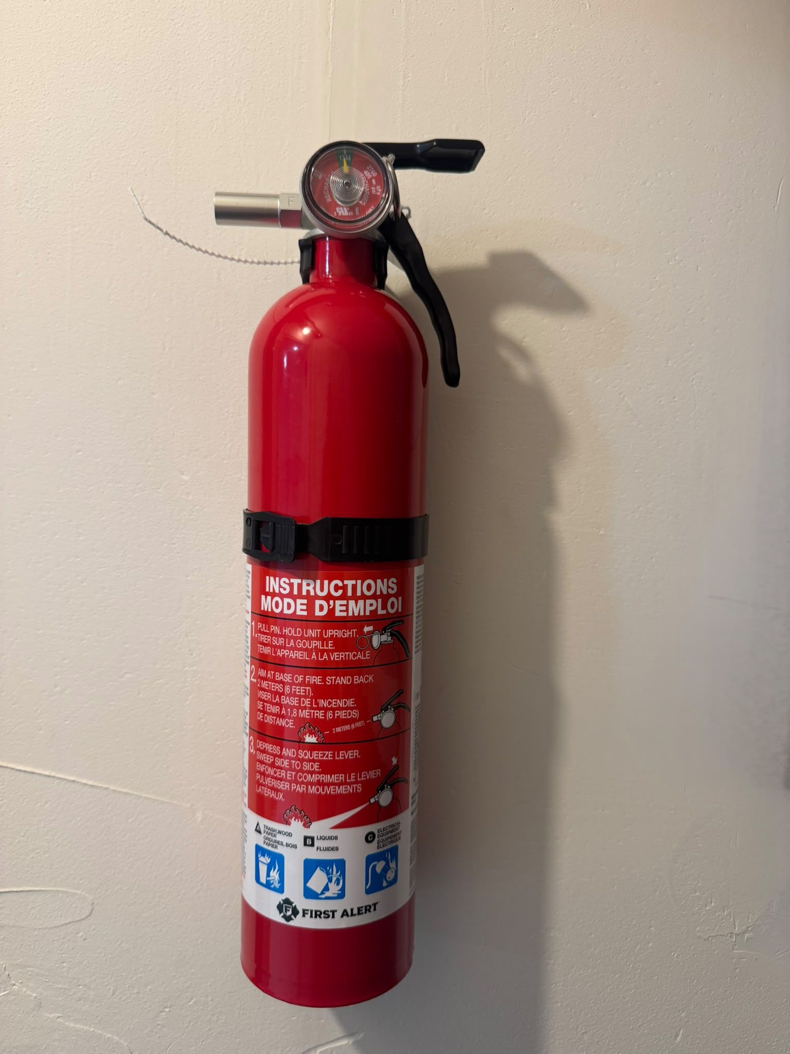 A red fire extinguisher mounted on a wall.