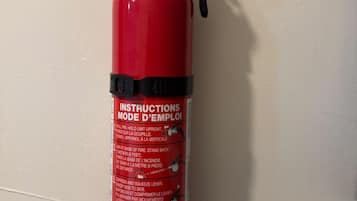 A red fire extinguisher mounted on a wall.