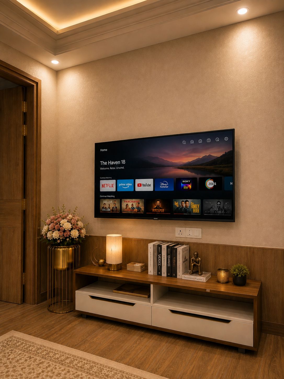 A modern living room with a flat-screen TV mounted on the wall displaying a streaming service interface.