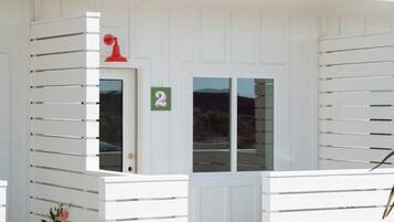 A white building with a number 2 sign, a door, and windows.