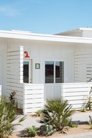 A white building with a number 2 sign, a door, and windows.