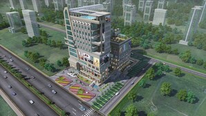 A multi-story building with a unique architectural design, surrounded by greenery and roads. - Sunday Hotel by CheckIn Greater Noida (Greater Noida)