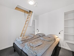 A bedroom with a bed, a ladder, and a white wardrobe. - "Boris" - 50m to the fjord by Interhome (Tarm)