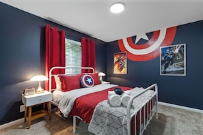 A bedroom with a bed, nightstand, lamp, curtains, and wall art. - Marvel-ous 4 BD/2.5 BA Home in Royal Oak (Royal Oak)