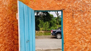 A vehicle entering a structure with a blue door.