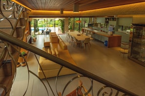 A spacious interior with a dining area, kitchen, and a staircase.