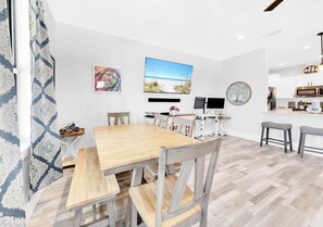 A modern kitchen with white cabinets, a microwave, and a coffee machine. - Lux Beach House - 2-Min Beach - Hot Tub - Dogs OK (Panama City Beach)