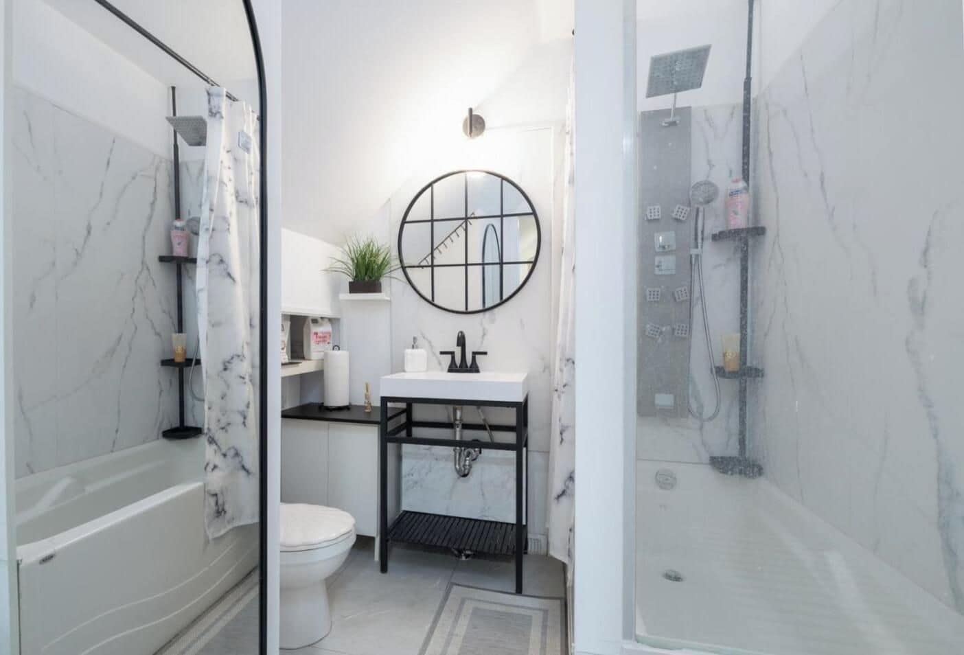 A bathroom with a toilet, sink, and shower area.