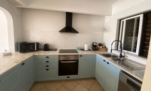 Eine kleine Küche mit Mikrowelle, Toaster und Geschirrspüler.