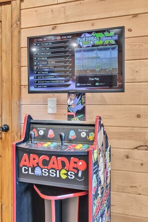 A video game console with a menu screen displaying various game options. - 8BR • 25 Beds • Indoor Pool • Tiki Bar • Hot Tub (Sevierville)