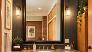A bathroom with a dark wood vanity, a large mirror, and a patterned rug on the floor. - Quinta Aurora - Relaxing Wine Country Casa w/Pool (San Marco)