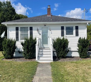 A single-story house with a front door, number 34, and a chimney. - Quaint 2-bedroom bungalow, close to the ocean in charming Thomaston (Thomaston)