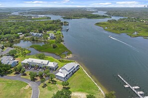 An aerial view of a residential area with a large body of water, a dock, and several houses. - Fully Remodeled "Coastal Luxe" with 1 mile of amazing River Views. Unmatched!! (Crystal River)