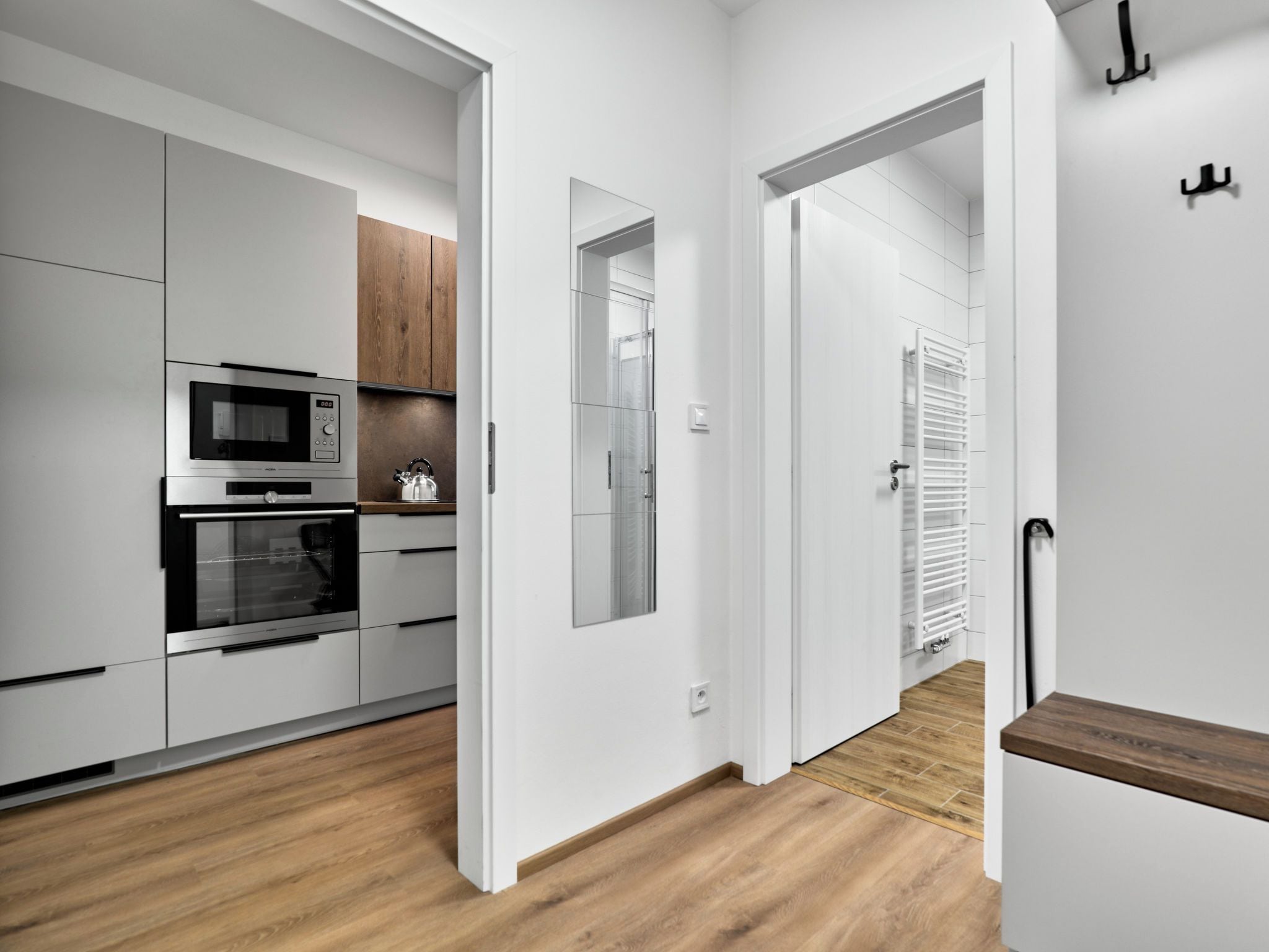 A modern kitchen with built-in appliances and wooden cabinets.