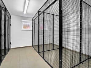 A corridor with metal cages, a tiled floor, and a framed picture on the wall. - Mánesova by Interhome (Jachymov)
