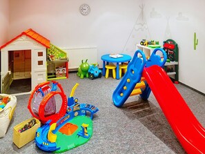 A children's play area with a playhouse, a slide, and various toys. - Ferienhaus Brigitte by Interhome (Längenfeld)